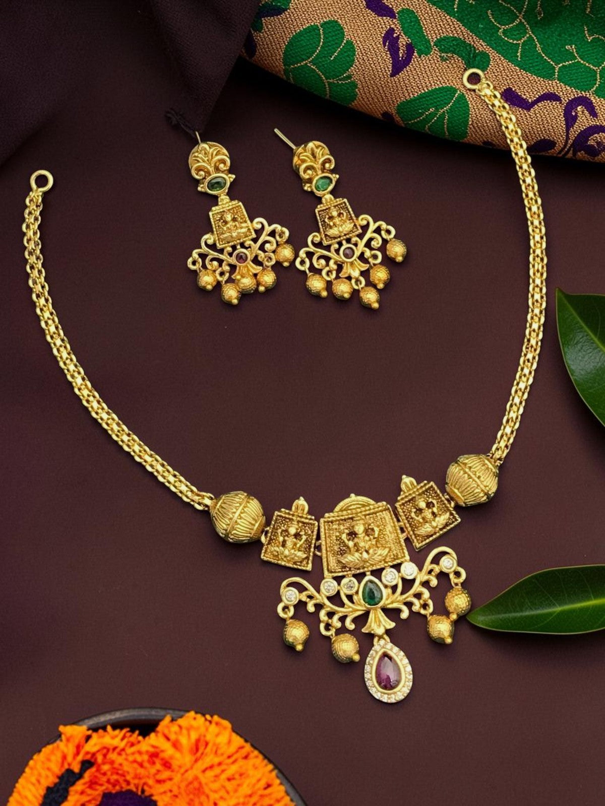 My Store gold-toned temple jewelry necklace and earring set with intricate motifs, green and ruby stones, and beads.
