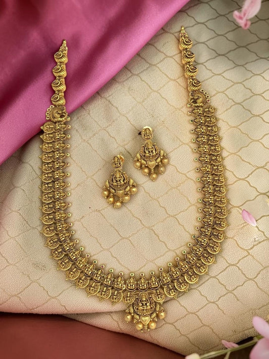 My Store antique gold-toned temple jewelry necklace and earring set with intricate deity motifs on white silk fabric.
