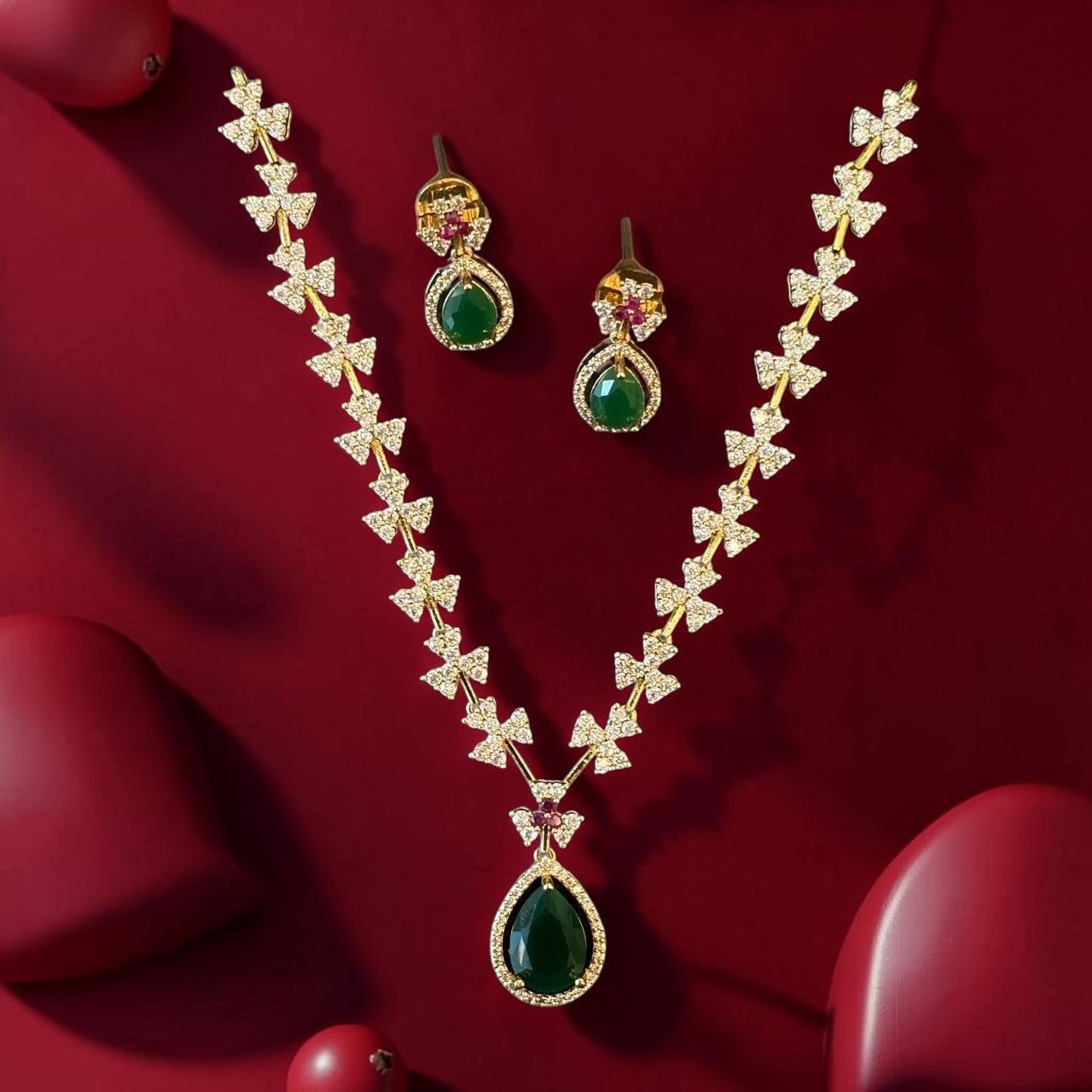 My Store gold-tone jewelry set featuring a teardrop green pendant necklace and matching floral-inspired earrings.