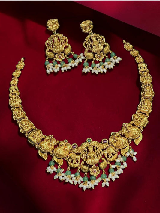 My Store gold-toned temple jewelry necklace set with Lakshmi motifs, pearls, and green beads with matching earrings.