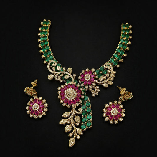 My Store Marakata Pushpavalli necklace set with emerald green stones, ruby floral motifs, and diamonds in gold tone.