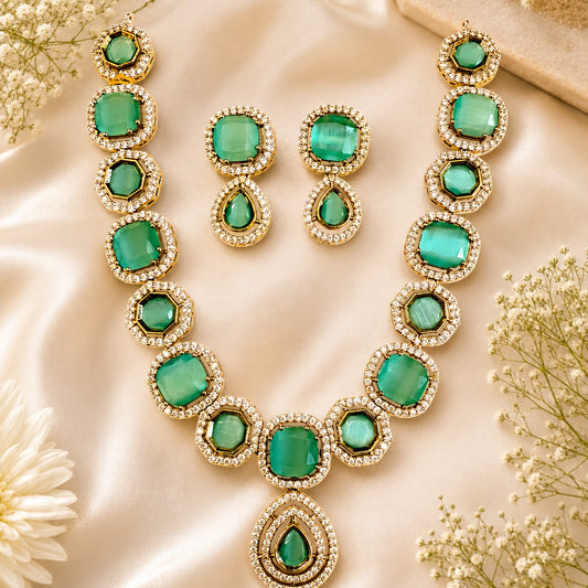 My Store Zymera necklace and earring set with green cat-eye stones, gold-tone settings, and clear crystal halos.